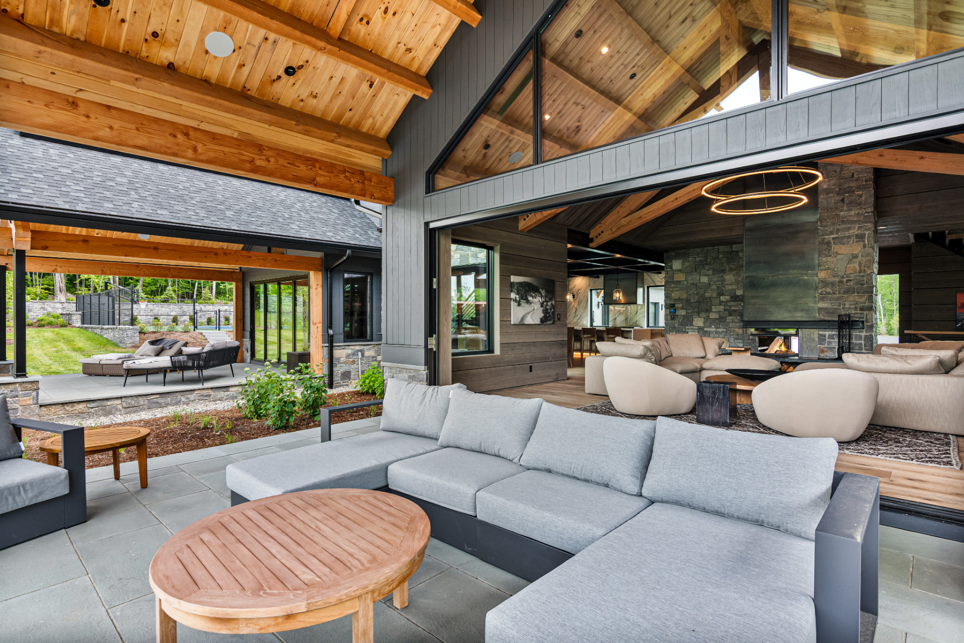 Indoor-outdoor patio living area with painted timber and stone details