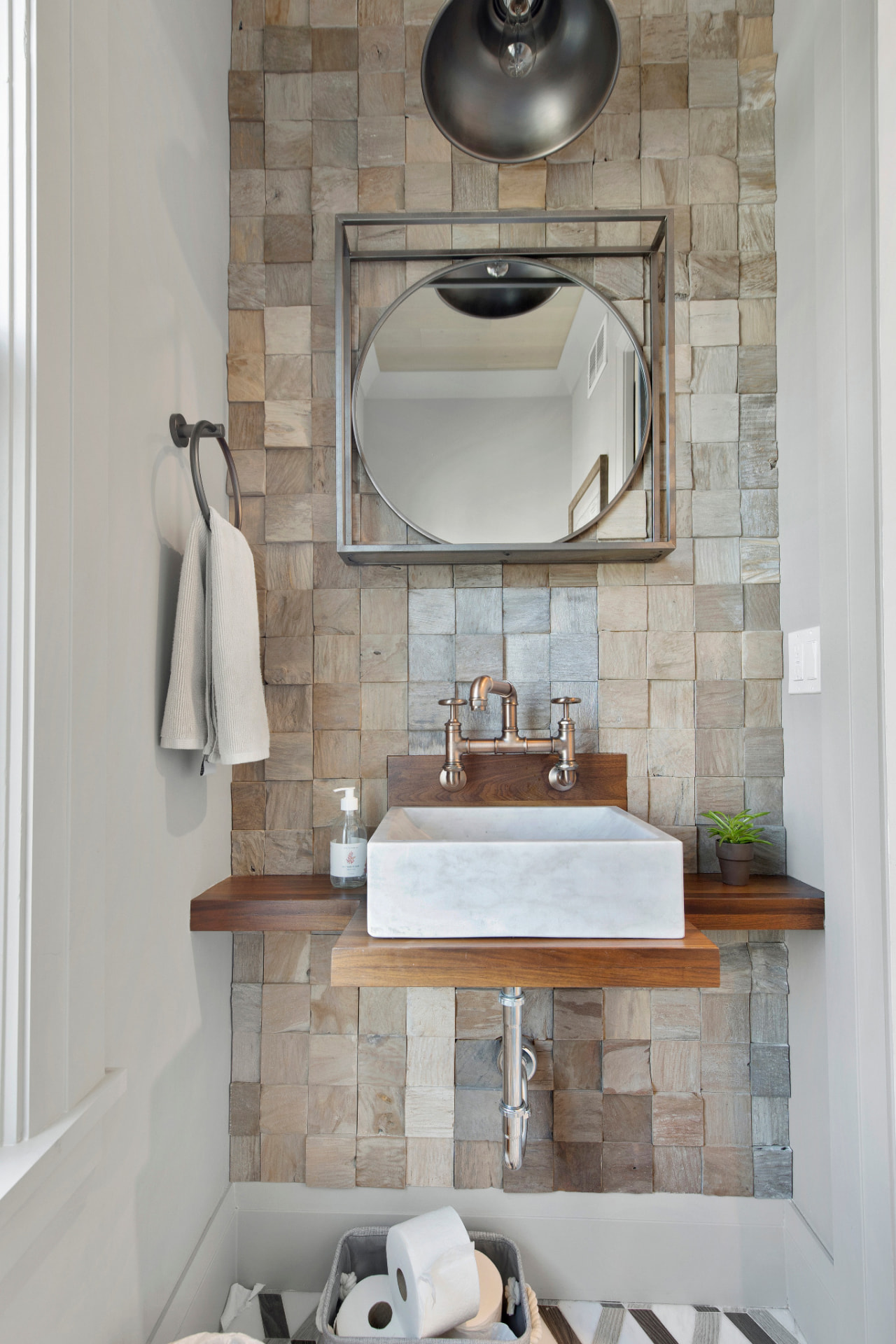 Powder room with painted white walls and wood accent wall