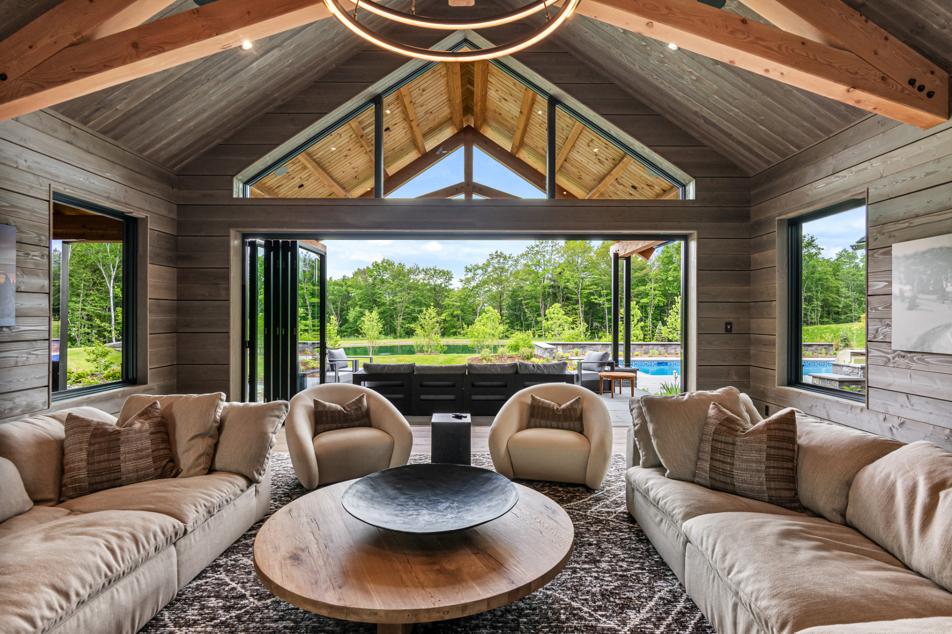 Pool house interior with vaulted timber ceiling and wood-clad walls