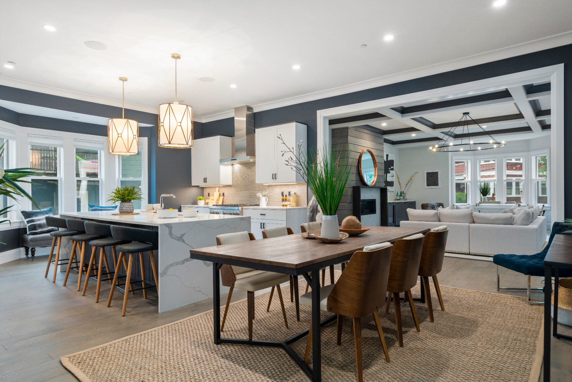 Open kitchen and dining area with navy walls and coffered ceilings